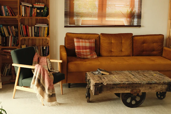 a living room with a couch, chair, coffee table and bookshelf