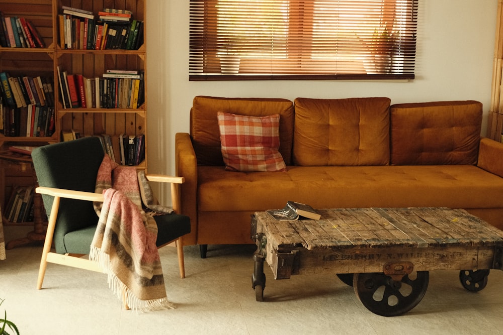 a living room with a couch, chair, coffee table and bookshelf