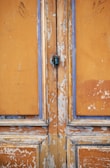 Before and after shots of a weathered door transformed by Rainbow Restoration.