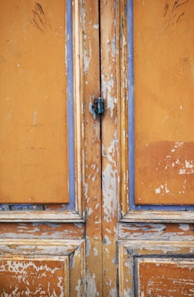 Before and after shots of a weathered door transformed by Rainbow Restoration.