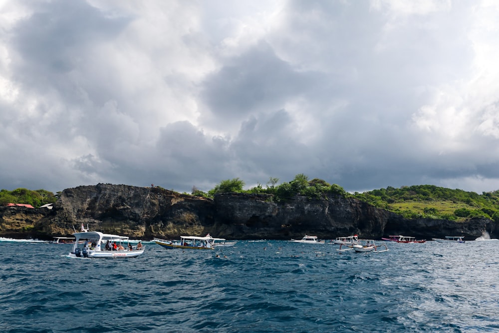 a group of boats floating on top of a body of water