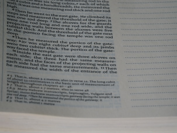 A close-up of a page from a book with printed text, mainly describing measurements and architectural details. The text appears in a structured format, possibly indicating a passage from a religious or historical document, with footnotes or references at the bottom.