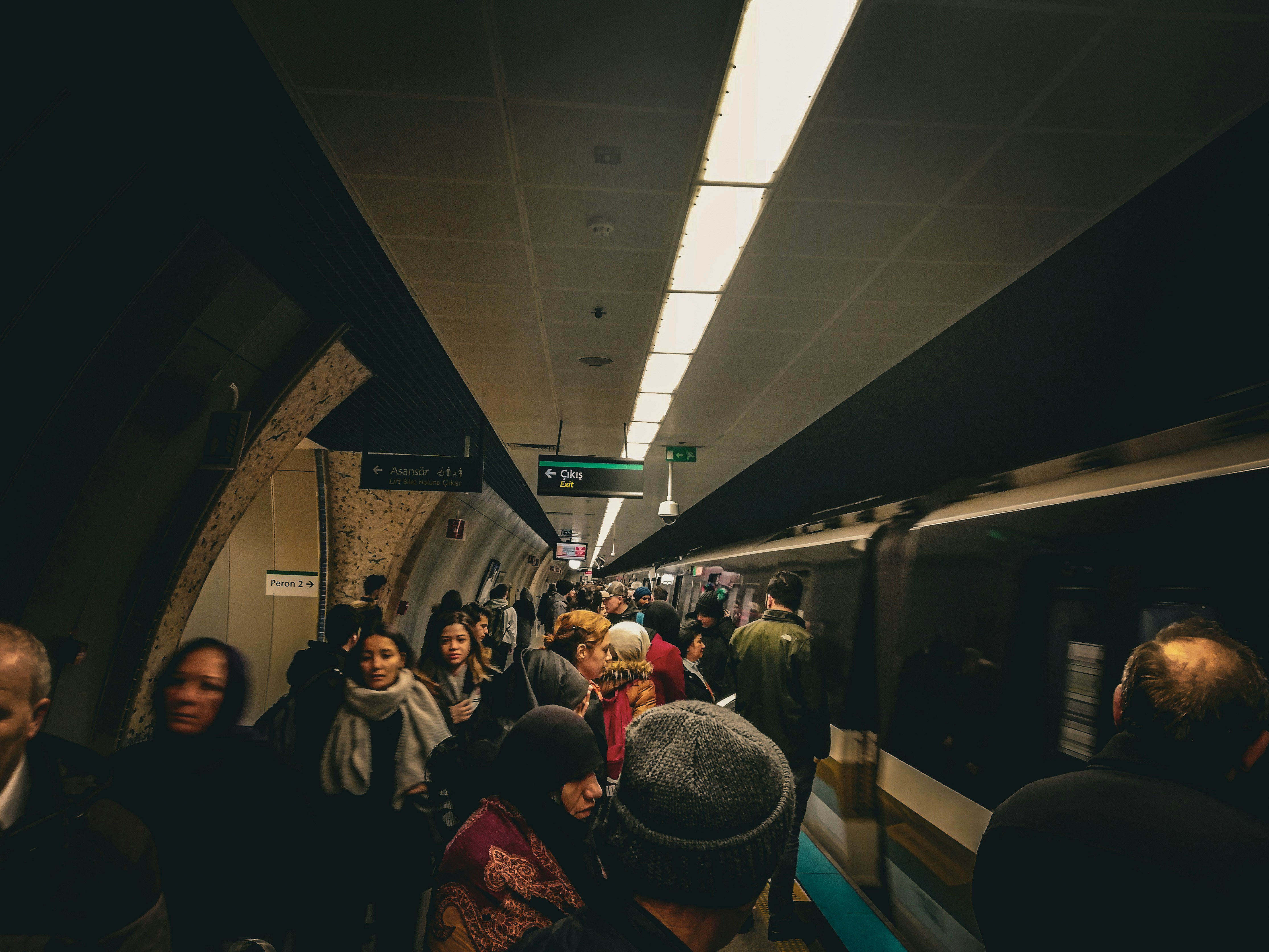 a group of people standing on a subway platform