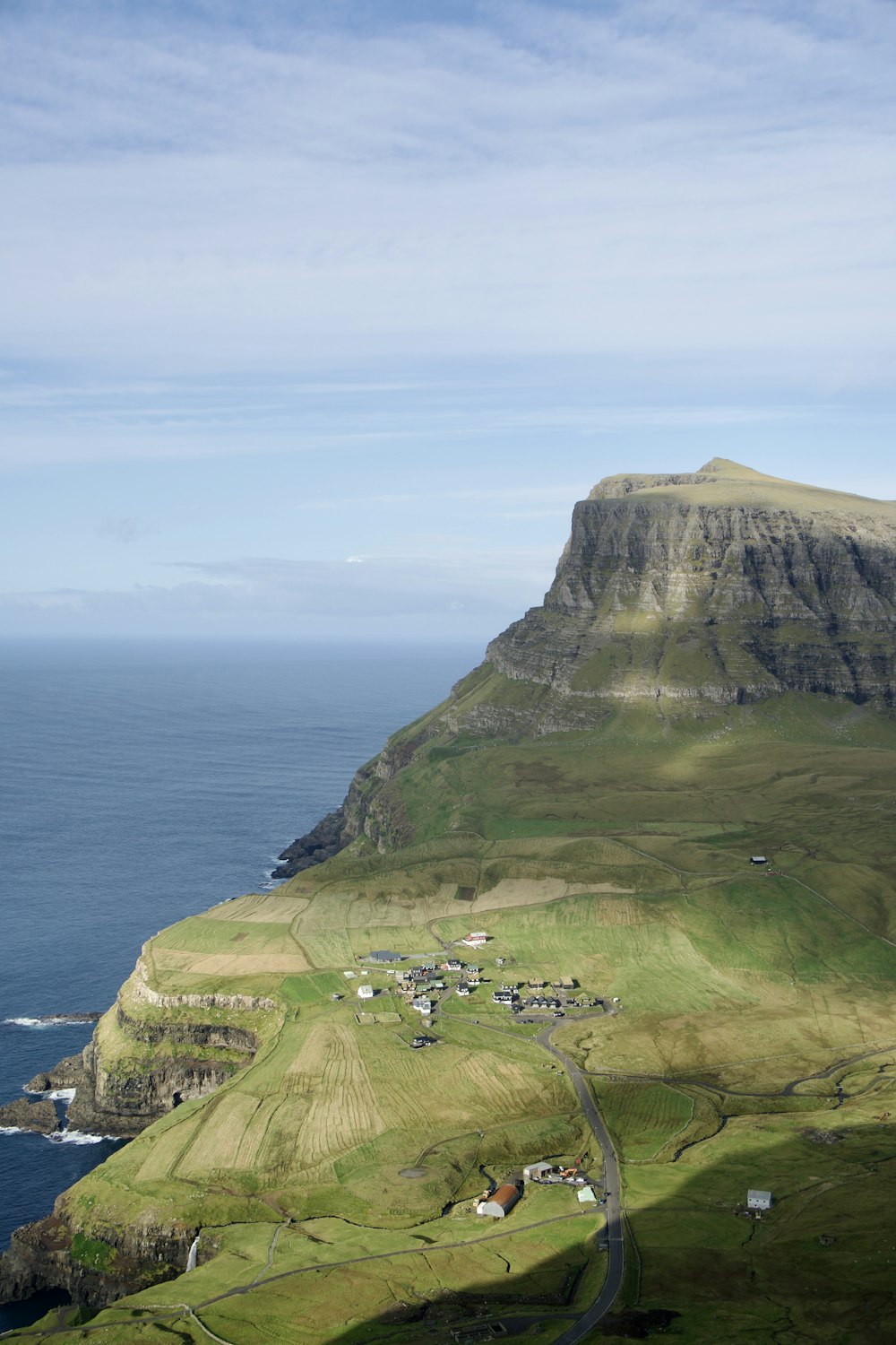 a scenic view of a small village on the side of a mountain