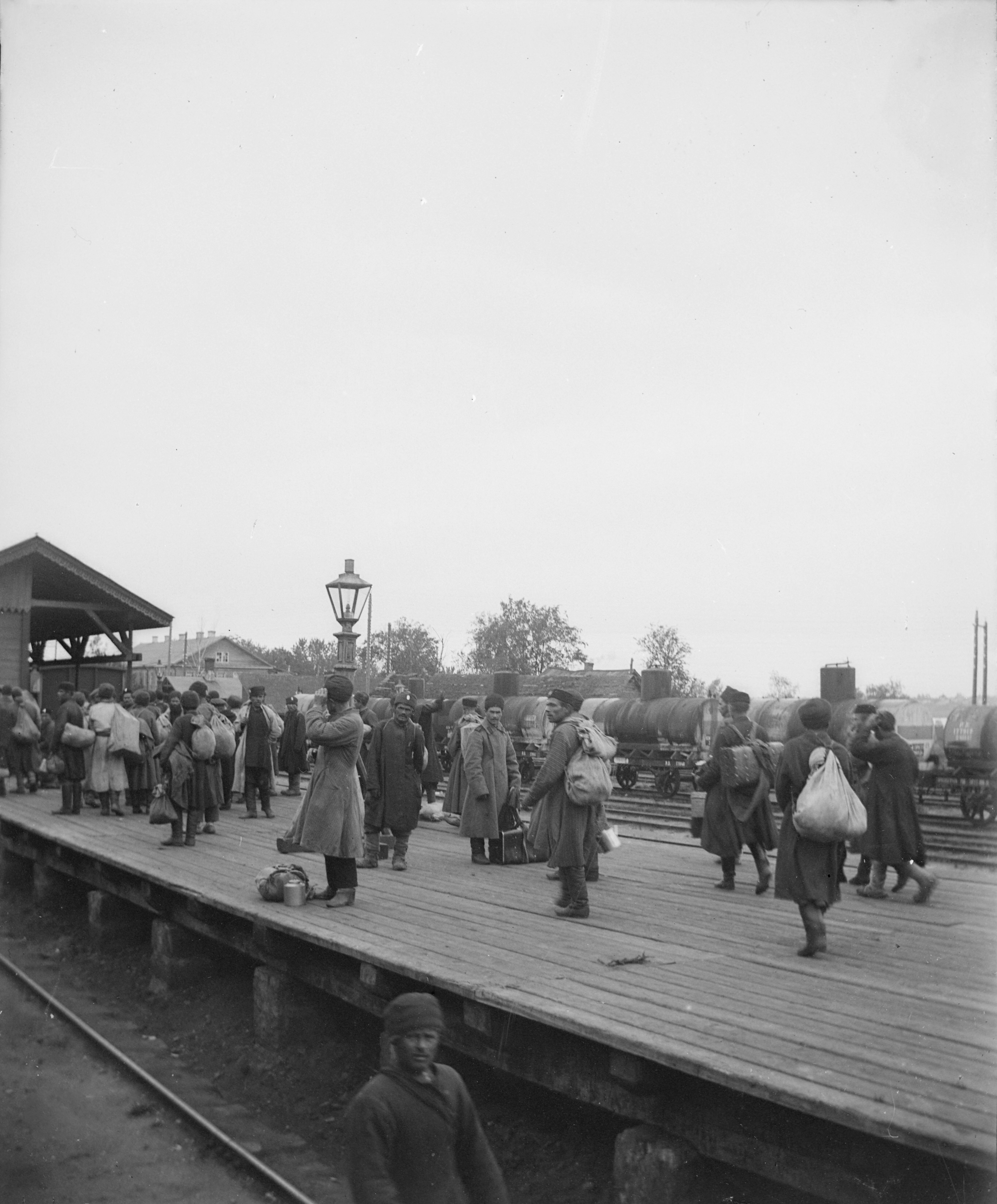 a group of people walking across a wooden bridge