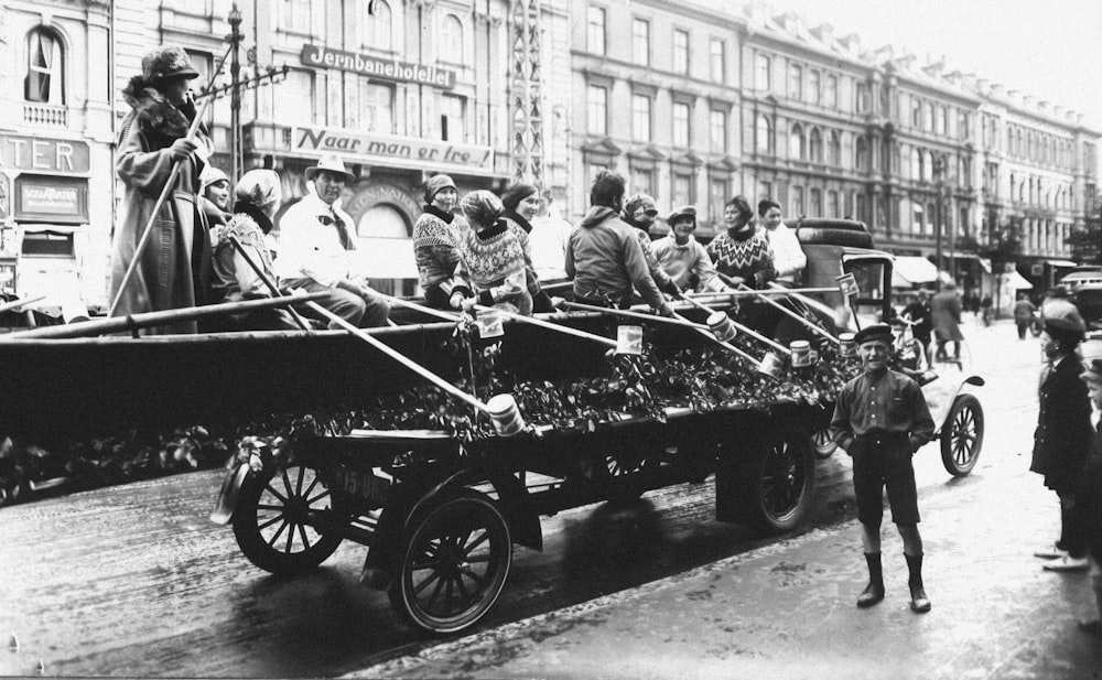 a group of people riding on the back of a horse drawn carriage