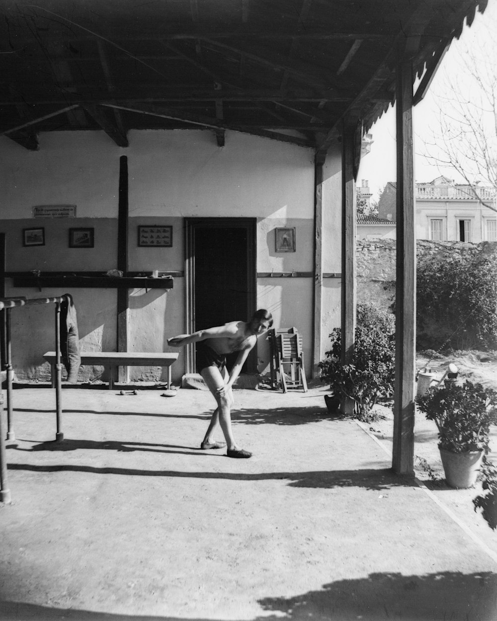 a black and white photo of a man holding a baseball bat