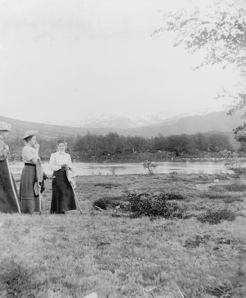 a group of women standing next to each other in a field