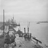 An old sepia-toned photo of a bustling 1870s American port town captured with rustic charm