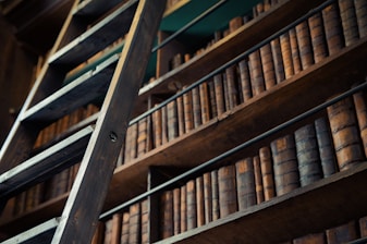 a ladder leaning against a bookshelf filled with books