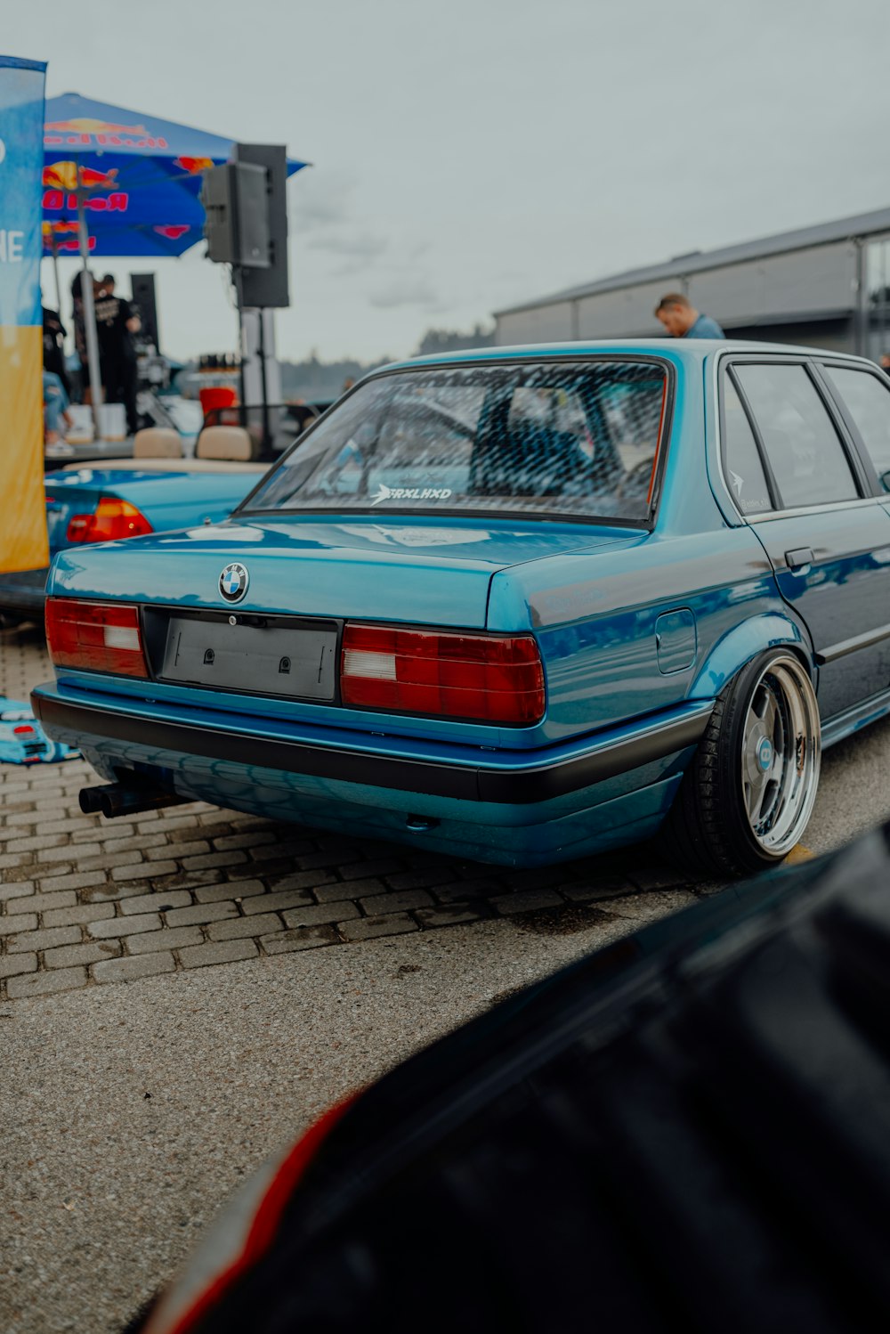 a blue car parked on the side of the road