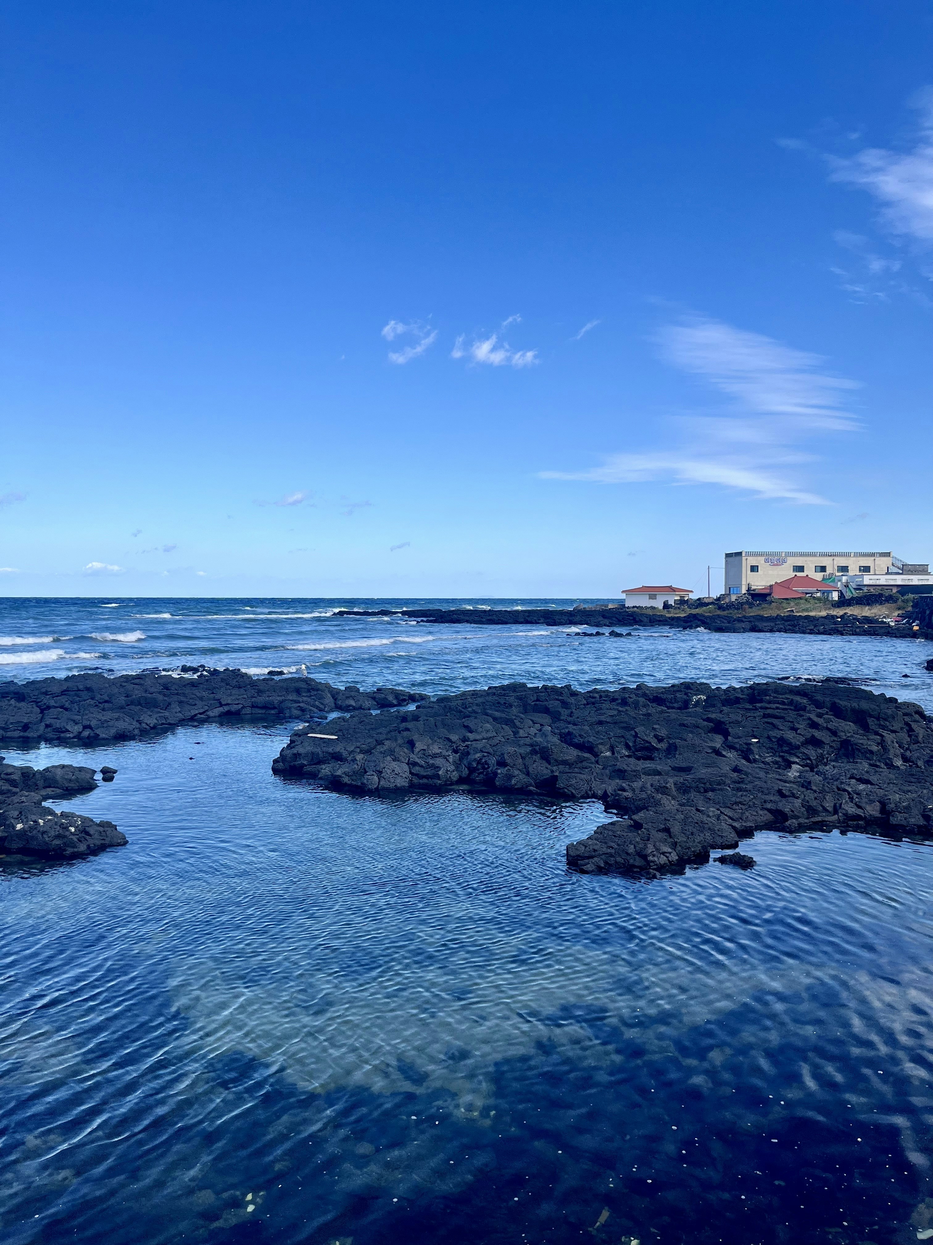a body of water surrounded by rocks and buildings