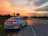 Elegant silver sedan parked by a scenic Nairobi street with sunset lighting.