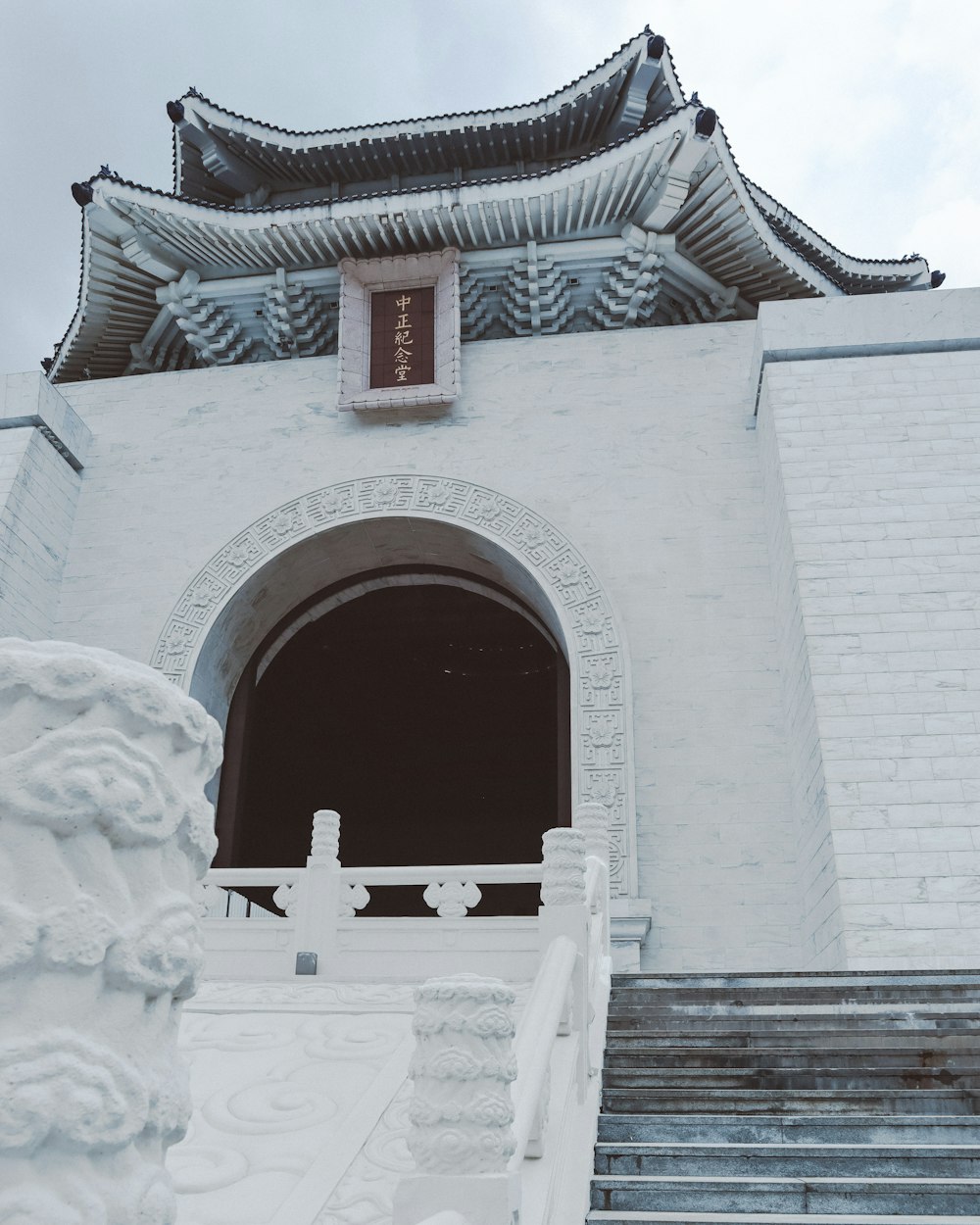 a large white building with a staircase leading up to it