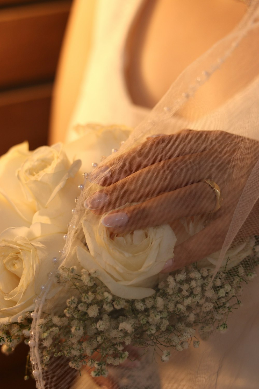 a close up of a person holding a bouquet of flowers