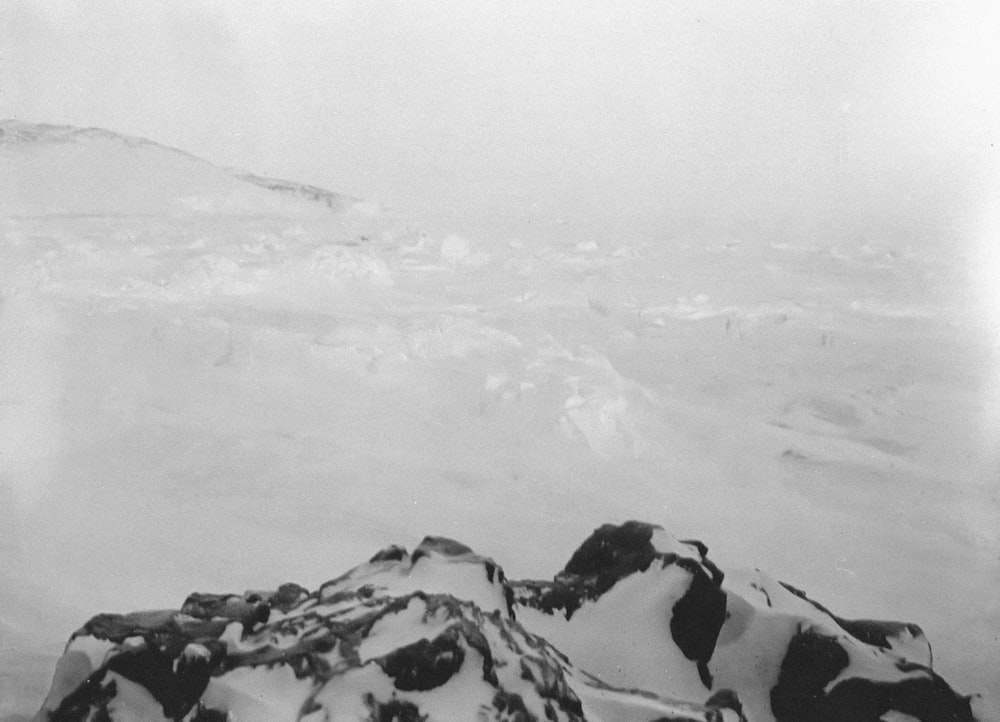 a black and white photo of snow covered mountains