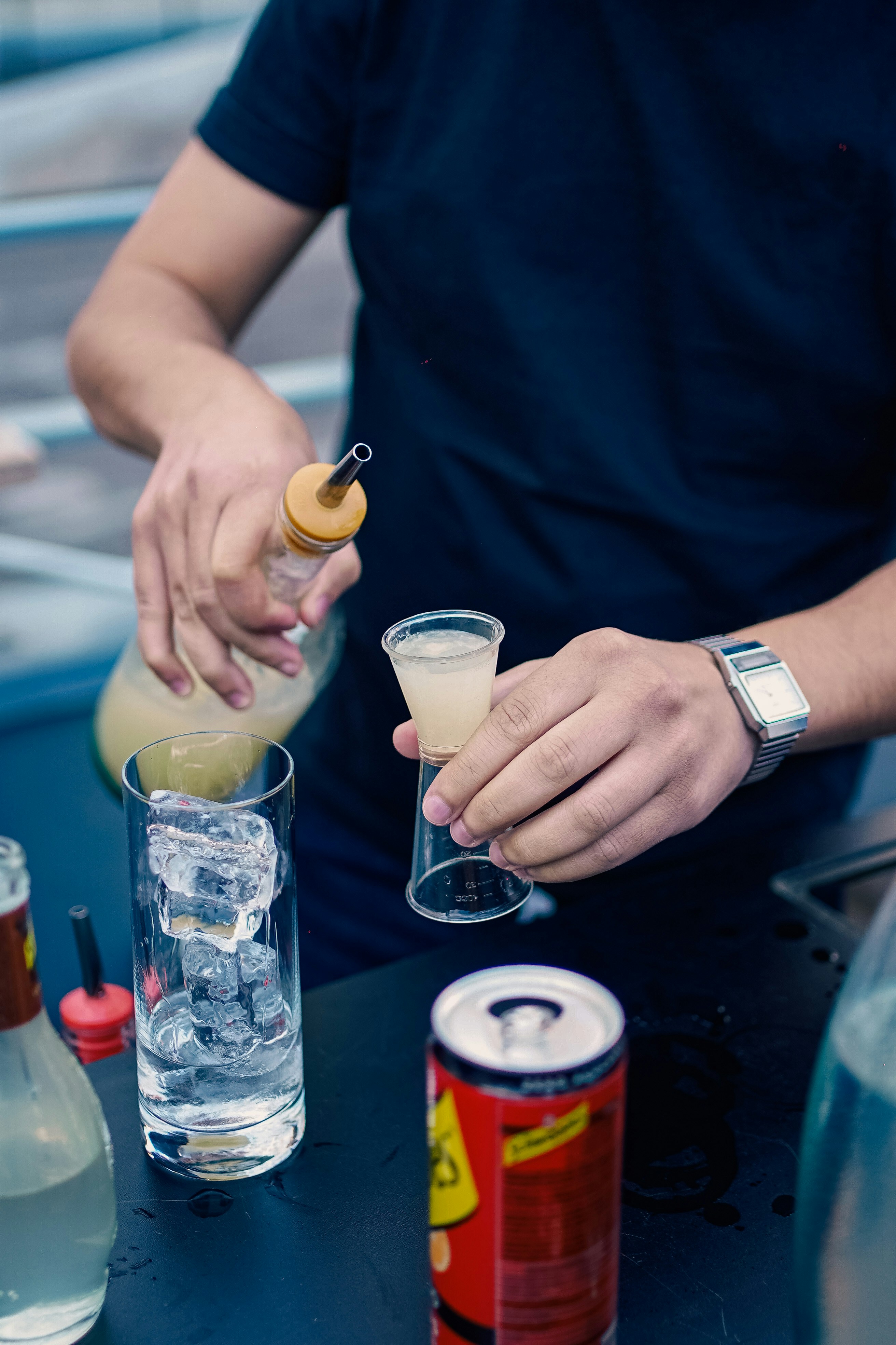 a man is pouring a drink into a glass