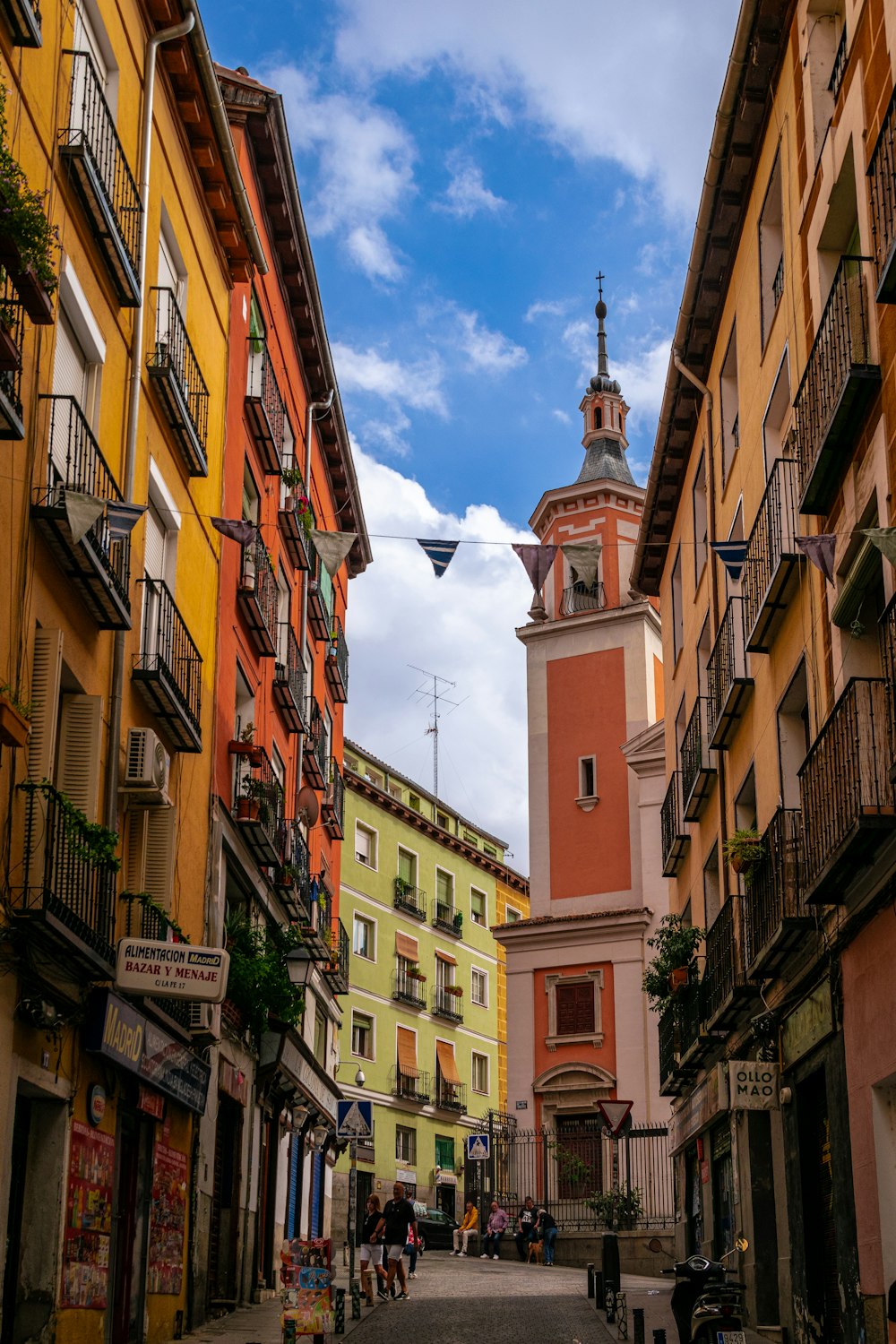 a clock tower towering over a city street