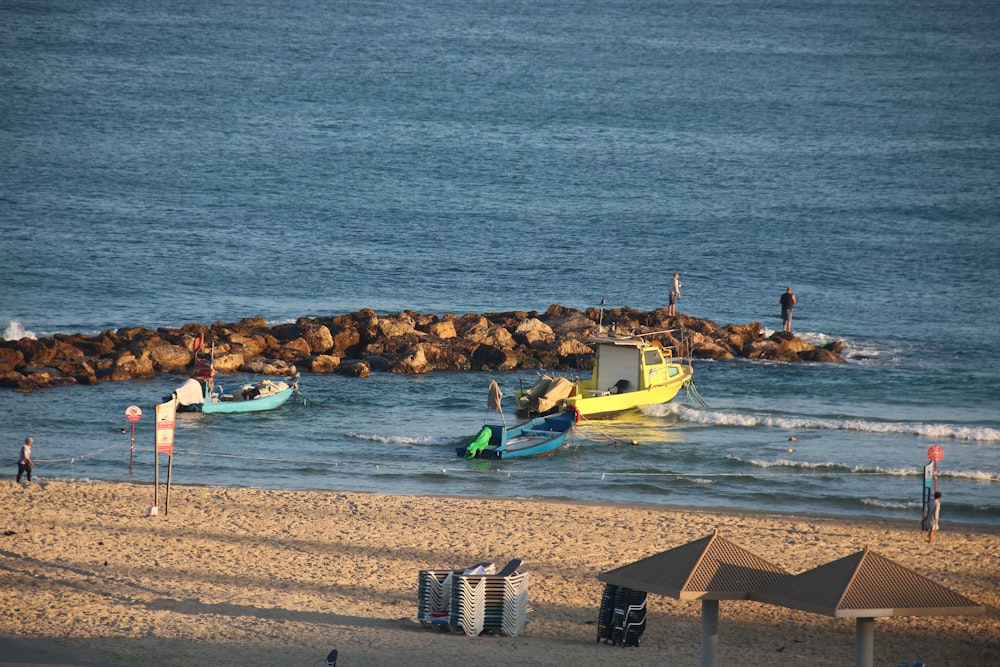 a group of people standing on top of a sandy beach