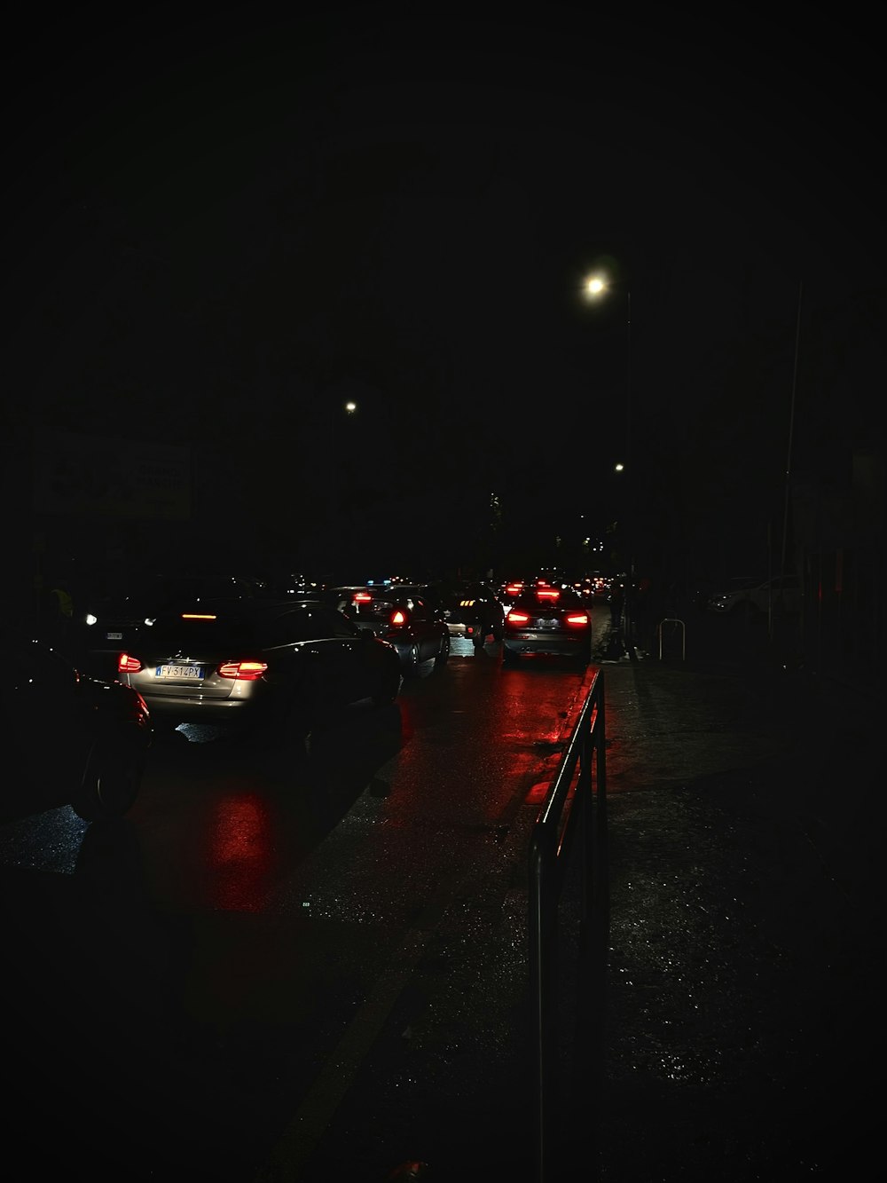 a street filled with lots of traffic at night