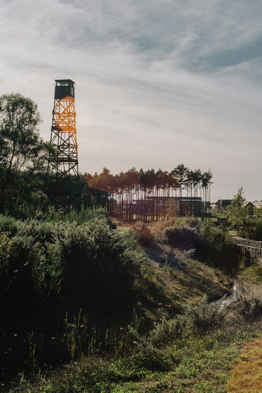 a tall tower sitting on top of a lush green hillside