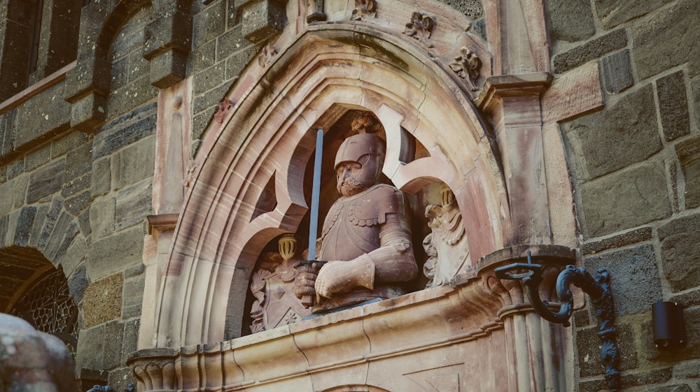 a statue of a man sitting in a window