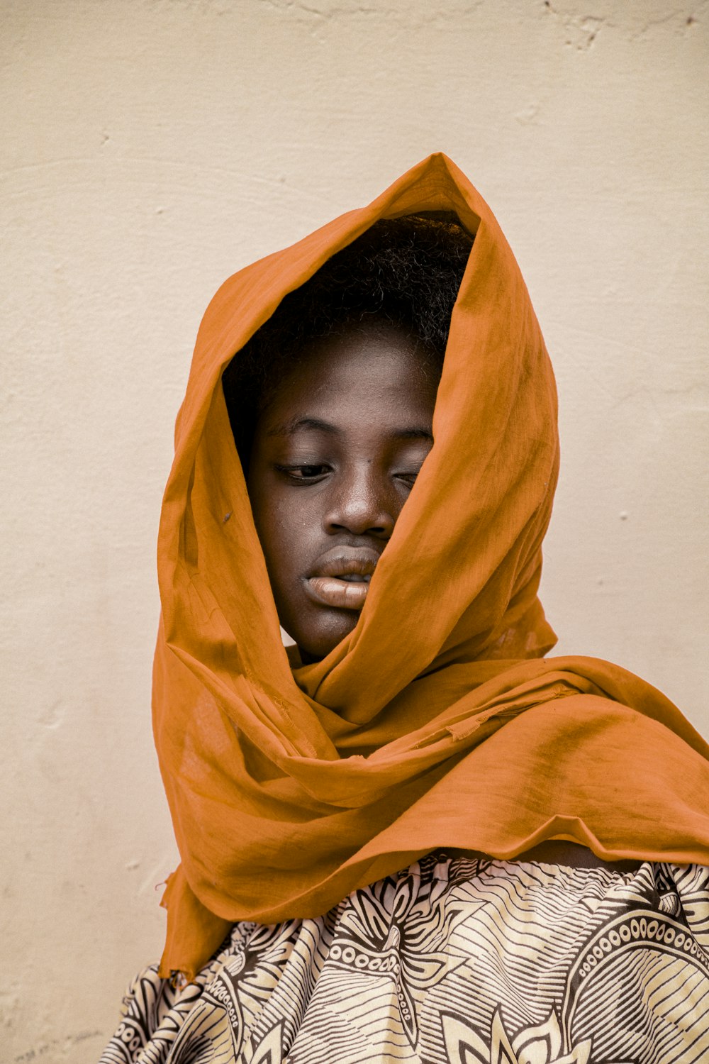 a young girl with a hood on her head