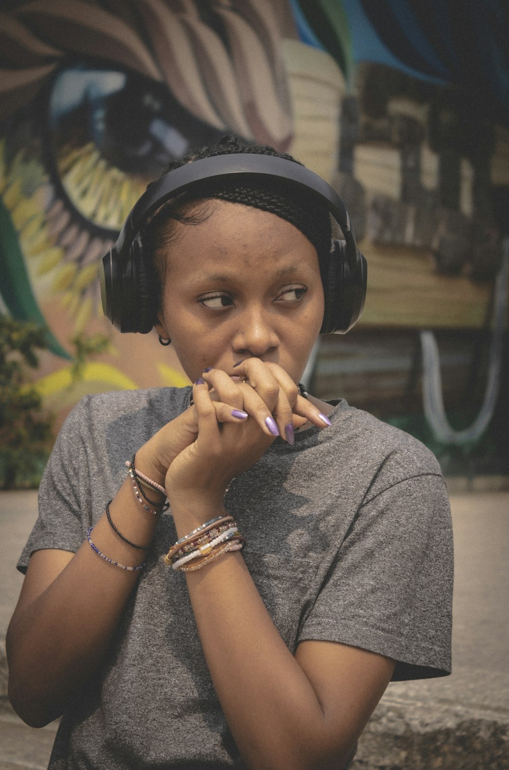 a woman wearing headphones and a gray shirt