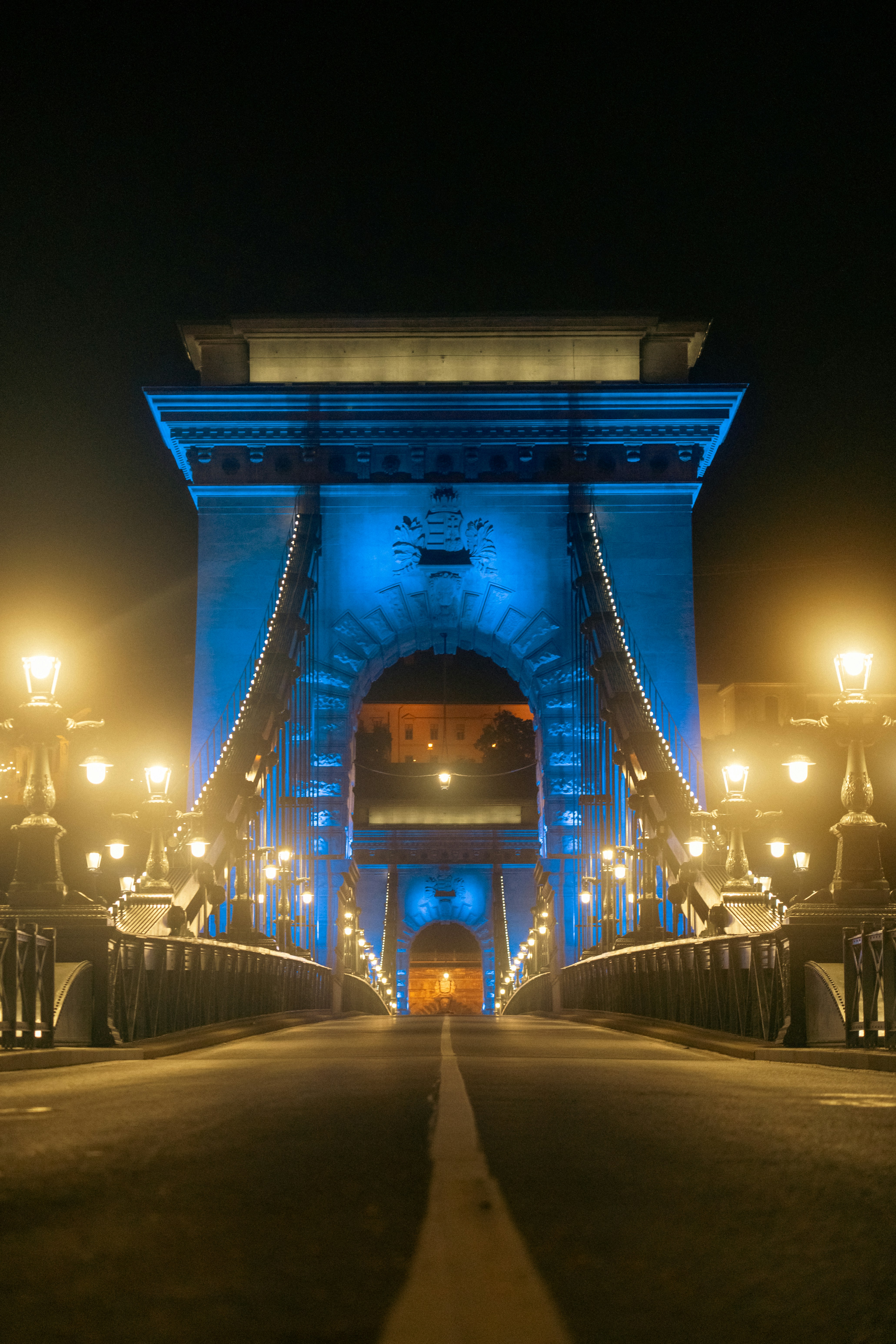 a bridge lit up with blue lights at night
