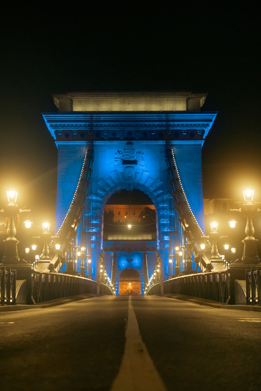 a bridge lit up with blue lights at night