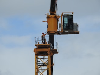 A construction worker wearing safety gear on a busy construction site.