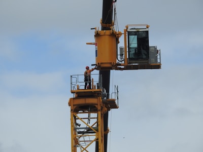 Close-up of a certified crane operator in safety gear controlling a crane.