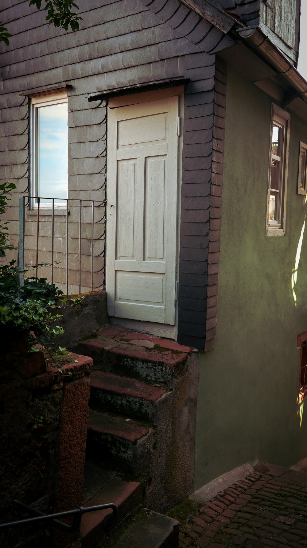 a house with a white door and steps leading up to it