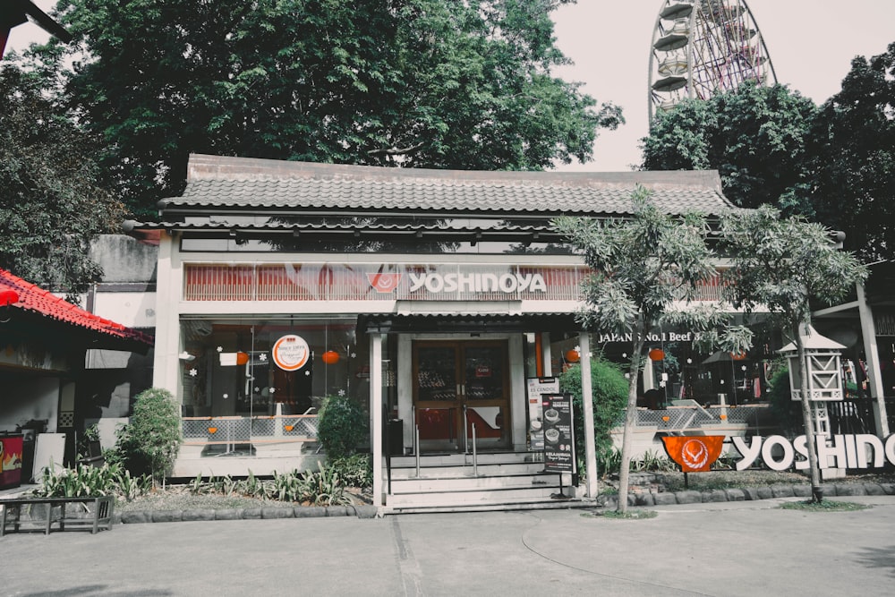 an asian restaurant with a ferris wheel in the background