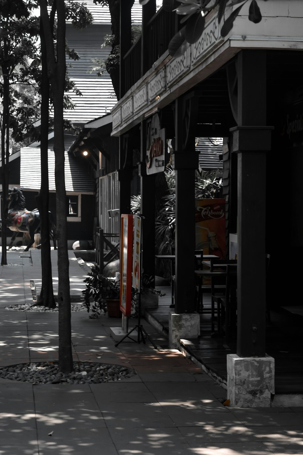 a black and white photo of a street corner