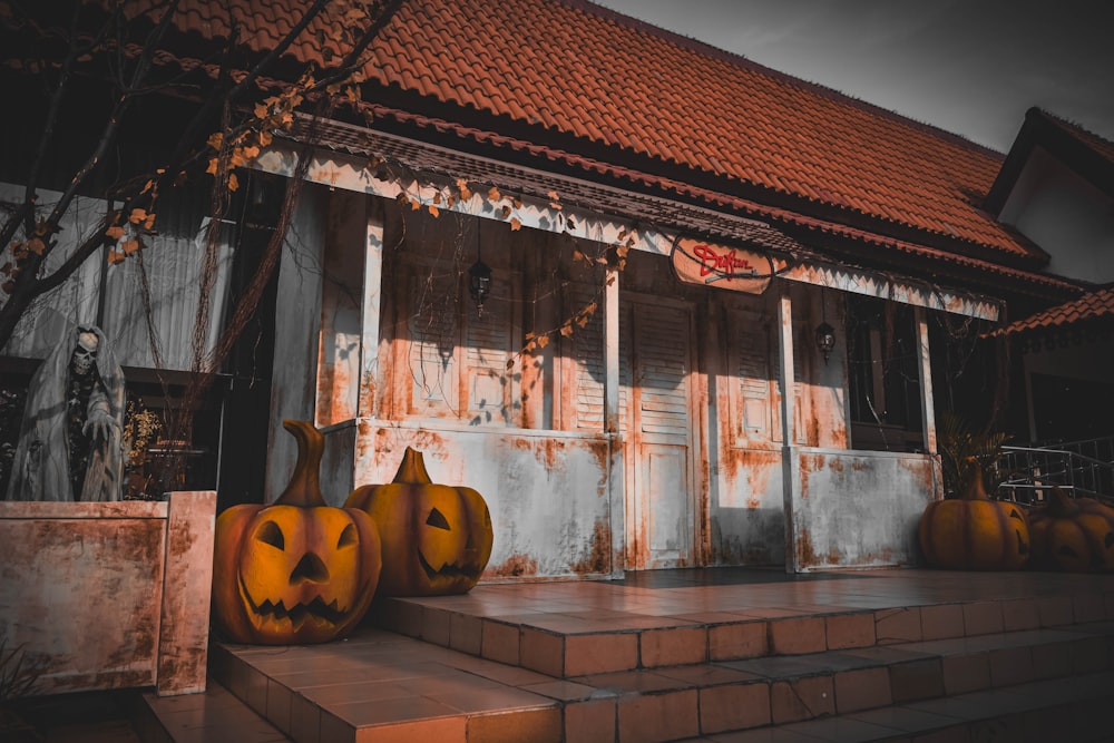 a couple of pumpkins that are sitting on some steps