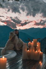 a woman sitting on a table with a dog