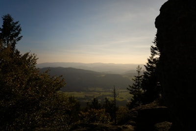 A serene landscape with soft hills and a gentle sunset.