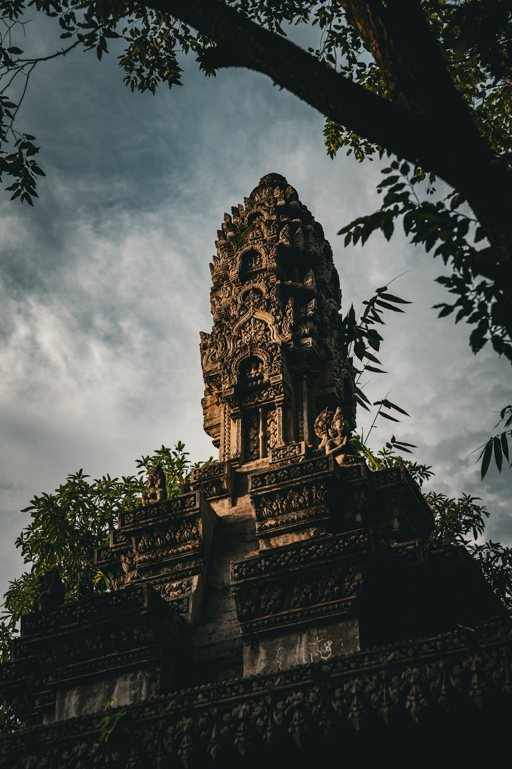 a very tall tower with a tree in front of it