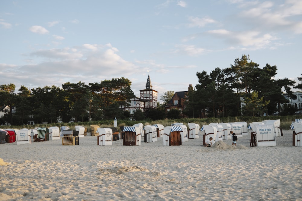 a row of beach chairs sitting on top of a sandy beach