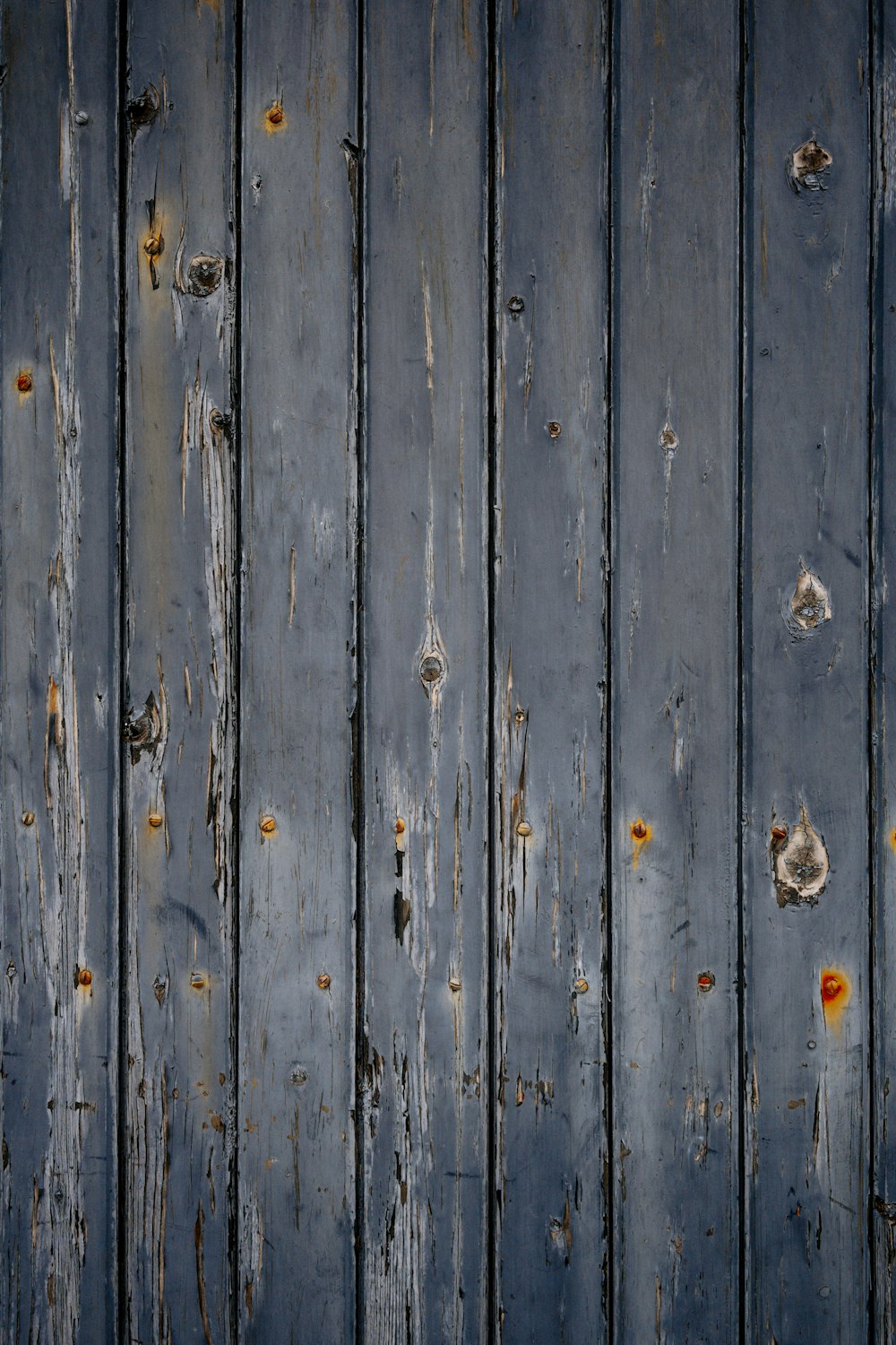 a close up of a wooden wall with peeling paint