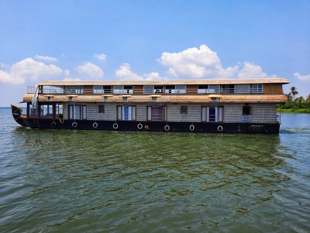 a house boat floating on top of a body of water