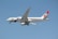A large commercial airplane with the Biman Bangladesh airlines livery on a clear day. The aircraft is in mid-flight, showcasing its sleek design and the airline's distinctive red and green logo on the tail.
