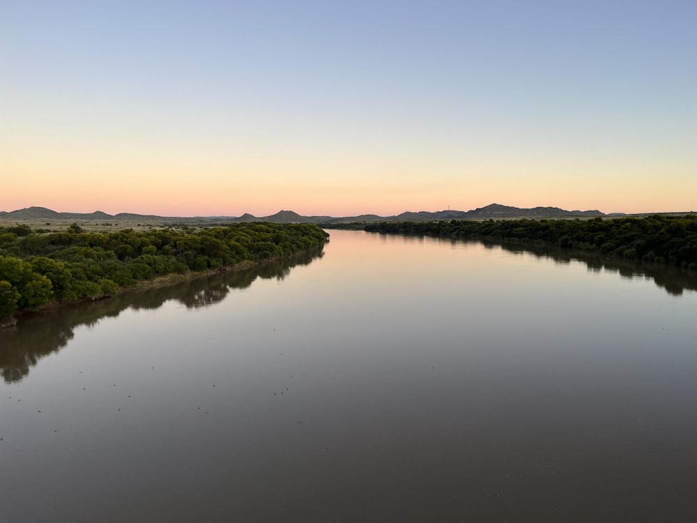 a large body of water surrounded by trees