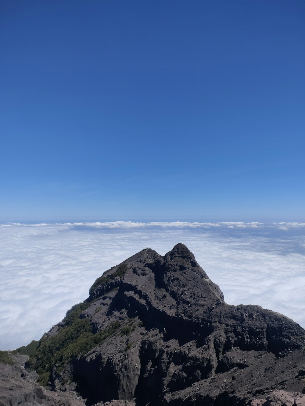 a view of the top of a mountain in the clouds