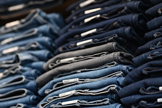 a pile of blue jeans sitting next to each other