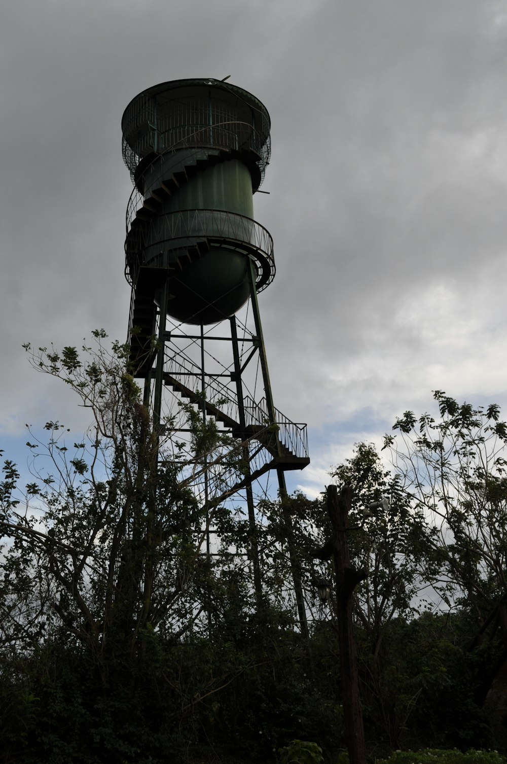 a tall metal tower with a sky background