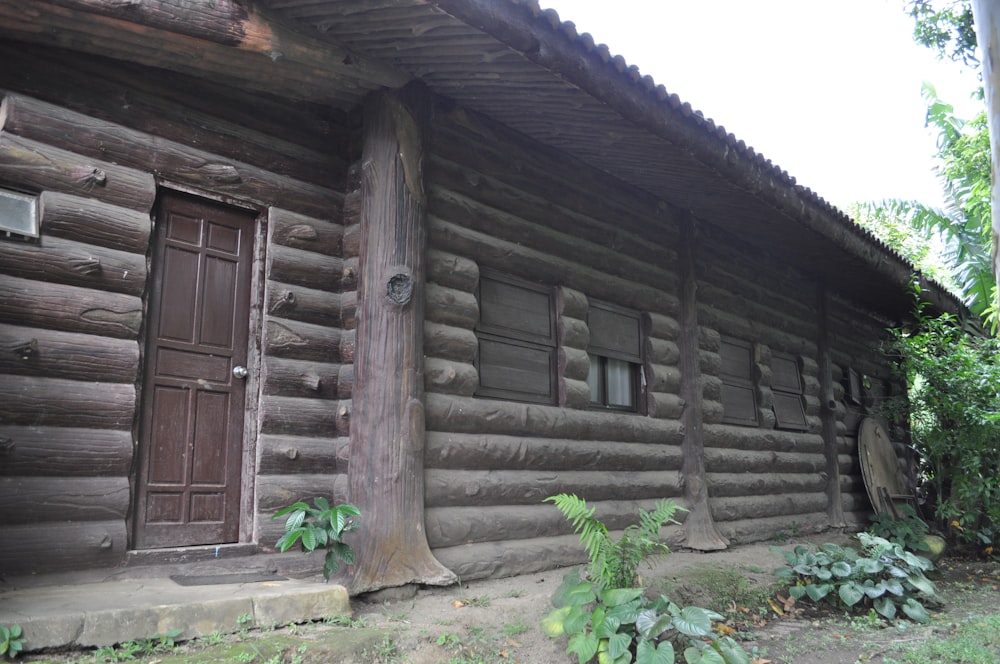 a log cabin with a wooden door and window