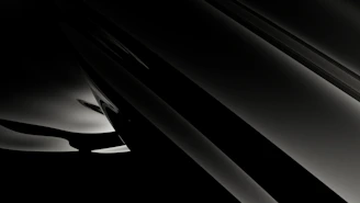 Monochrome abstract geometric shapes layered with subtle gold accents, evoking a sense of minimalist luxury.