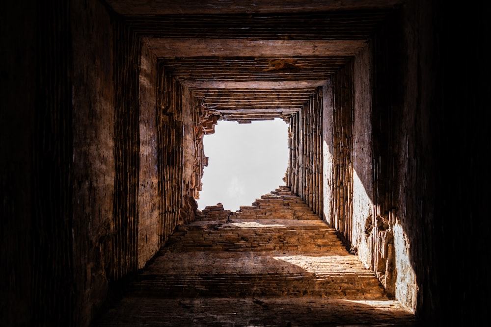 a very long narrow tunnel with a sky in the background